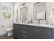 Elegant bathroom with a double vanity, quartz countertop, and modern fixtures, providing a luxurious feel at 1010 Cobb St, Durham, NC 27707