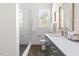 Bright bathroom featuring a modern shower, stylish vanity, and ample natural light at 1010 Cobb St, Durham, NC 27707