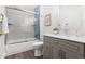 Well-lit bathroom featuring a shower-tub, modern vanity, and a decorative plant at 1010 Cobb St, Durham, NC 27707