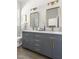 Elegant bathroom with a double vanity, quartz countertop, and modern fixtures, providing a luxurious feel at 1010 Cobb St, Durham, NC 27707