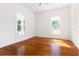 Spacious bedroom featuring gleaming hardwood floors, natural light, and inviting ambiance at 1010 Cobb St, Durham, NC 27707