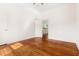 Bright bedroom with hardwood floors and a view into the adjacent kitchen at 1010 Cobb St, Durham, NC 27707