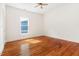 Bright bedroom showcasing hardwood floors and ample natural light from a sunlit window at 1010 Cobb St, Durham, NC 27707