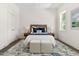 Serene bedroom featuring a comfortable bed with a woven headboard and stylish bedside decor at 1010 Cobb St, Durham, NC 27707