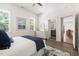 Bright bedroom with stylish decor, showcasing the ensuite bathroom at 1010 Cobb St, Durham, NC 27707