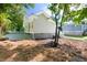 This house features gravel landscaping, a grey painted brick foundation, and light tan siding at 1010 Cobb St, Durham, NC 27707