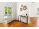 Bright foyer featuring hardwood floors, white walls, and a view into the living area at 1010 Cobb St, Durham, NC 27707