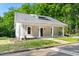 Charming home featuring a covered porch with white columns and a landscaped front yard at 1010 Cobb St, Durham, NC 27707