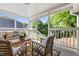 Inviting covered porch with comfortable seating, stylish rugs, and a view of the lush backyard at 1010 Cobb St, Durham, NC 27707