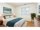 Cozy bedroom with natural light, a comfortable bed, and hardwood floors at 1015 Boathouse Ct, Raleigh, NC 27615