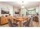 Elegant dining room with a wooden table, seating for six, modern lighting, and seamless flow to the kitchen at 1015 Boathouse Ct, Raleigh, NC 27615