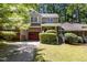 Inviting home with a brick and siding facade, a red garage door, and well-maintained landscaping at 1015 Boathouse Ct, Raleigh, NC 27615