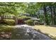 Charming home featuring a red garage door, brick accents, and a well-manicured front yard at 1015 Boathouse Ct, Raleigh, NC 27615