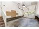 Spacious garage featuring a rolling garage door and a staircase leading to an upper level at 1015 Boathouse Ct, Raleigh, NC 27615