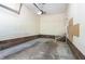 Spacious garage with an unfinished concrete floor, brick trim, and a staircase leading to the home at 1015 Boathouse Ct, Raleigh, NC 27615