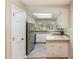 Well-lit kitchen with stainless steel appliances and tile flooring, featuring ample countertop space at 1015 Boathouse Ct, Raleigh, NC 27615