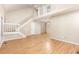 Bright living room featuring vaulted ceilings, stairs, and wood flooring at 1015 Boathouse Ct, Raleigh, NC 27615