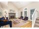 Bright living room featuring a fireplace, vaulted ceilings, stylish furniture and large windows providing ample natural light at 1015 Boathouse Ct, Raleigh, NC 27615