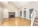 Bright living room with hardwood floors, a fireplace, vaulted ceilings, and a staircase at 1015 Boathouse Ct, Raleigh, NC 27615