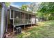 A charming screened porch extends to a well maintained yard with views of lush greenery at 1015 Boathouse Ct, Raleigh, NC 27615