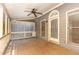 Inviting screened porch featuring a ceiling fan, wood floors, and an arched door at 1015 Boathouse Ct, Raleigh, NC 27615