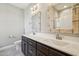 Bathroom featuring double sinks, dark vanity, decorative mirrors, and tiled floors at 10504 Carsons Creek Dr, Zebulon, NC 27597