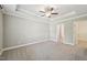Spacious bedroom with neutral walls, carpet, ceiling fan, and a walk-in closet at 10504 Carsons Creek Dr, Zebulon, NC 27597