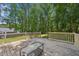Exterior deck with wood flooring and wooden railing overlooking a lush backyard at 10504 Carsons Creek Dr, Zebulon, NC 27597