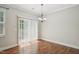 Well-lit dining room with hardwood floors and sliding glass doors to backyard at 10504 Carsons Creek Dr, Zebulon, NC 27597