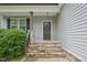 Inviting front porch with stone steps and decorative wreath on front door at 10504 Carsons Creek Dr, Zebulon, NC 27597