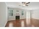 Bright living room featuring a fireplace, hardwood floors and ample natural light at 10504 Carsons Creek Dr, Zebulon, NC 27597