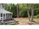 Backyard with a screened-in porch, wooden deck, tall trees, and privacy at 106 Windstream Way, Cary, NC 27518