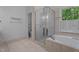 Bright bathroom features a shower, a tub, tile floors, and double sinks at 106 Windstream Way, Cary, NC 27518