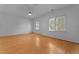 Bedroom featuring hardwood floors, two windows with blinds, and a ceiling fan at 106 Windstream Way, Cary, NC 27518