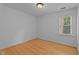 Bedroom featuring a window with blinds, hardwood floors and white walls at 106 Windstream Way, Cary, NC 27518
