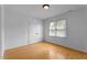 Bright bedroom featuring a double door closet, a window, and a hardwood floor at 106 Windstream Way, Cary, NC 27518