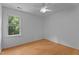 Bright bedroom featuring a ceiling fan and a window with view of greenery at 106 Windstream Way, Cary, NC 27518