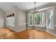 Well-lit dining room boasting a decorative chandelier and multiple windows overlooking the surrounding greenery at 106 Windstream Way, Cary, NC 27518