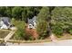 Aerial view showcases this beautiful home and landscaped yard, surrounded by mature trees at 106 Windstream Way, Cary, NC 27518