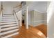 Open foyer featuring wood floors, stairs, and view into living spaces at 106 Windstream Way, Cary, NC 27518