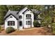 Charming white brick home featuring black accents and mature landscaping at 106 Windstream Way, Cary, NC 27518