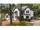 Lovely two-story home with white siding, dark trim, and lush landscaping at 106 Windstream Way, Cary, NC 27518