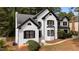 Well-maintained white brick home with black trim and manicured lawn at 106 Windstream Way, Cary, NC 27518