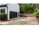 Exterior view of the garage showcasing the dark door and fenced yard at 106 Windstream Way, Cary, NC 27518