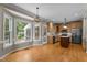 Eat-in kitchen featuring an island, stainless steel appliances, and a bright breakfast nook overlooking the backyard at 106 Windstream Way, Cary, NC 27518
