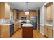 Spacious kitchen with stainless steel appliances, an island, and wood cabinets at 106 Windstream Way, Cary, NC 27518