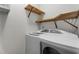 Laundry room with shelving above washer and dryer offers practical storage solutions at 106 Windstream Way, Cary, NC 27518