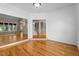 Bright living room featuring hardwood floors, fresh white walls, and staircase access to the upper floor at 106 Windstream Way, Cary, NC 27518