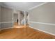 Inviting living room featuring hardwood floors, fresh gray walls, and staircase access to the upper floor at 106 Windstream Way, Cary, NC 27518