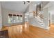 Bright living room with hardwood floors, large windows, and staircase at 106 Windstream Way, Cary, NC 27518